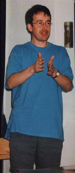 John Billingham flaps his hands around to indicate something or the other.