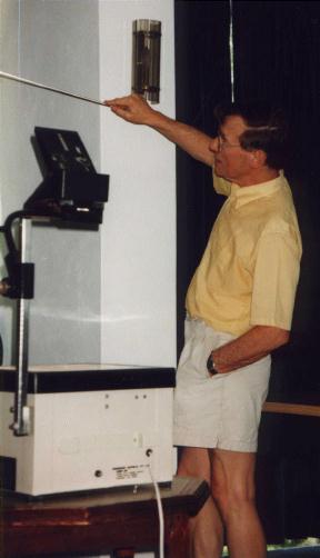 John Brindley casually uses the pointer, hand in pocket.