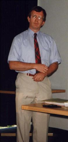 Andy McIntosh stares quizzically at the audience whilst pulling his trousers up.